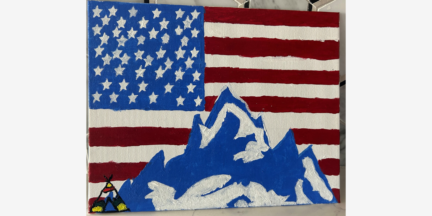 Painted blue and white mountains on top of American flag